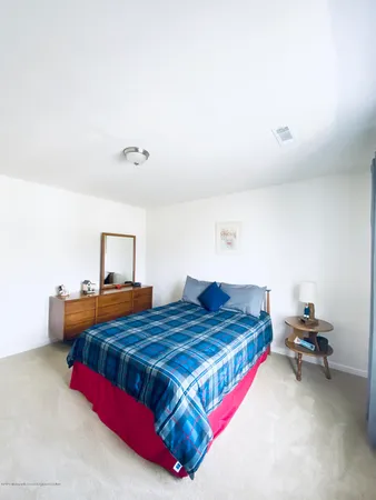 a bedroom with a bed and a chair