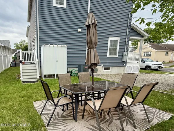 a view of a patio with table and chairs and potted plants