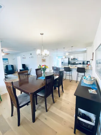 a dining area with furniture and a view of kitchen