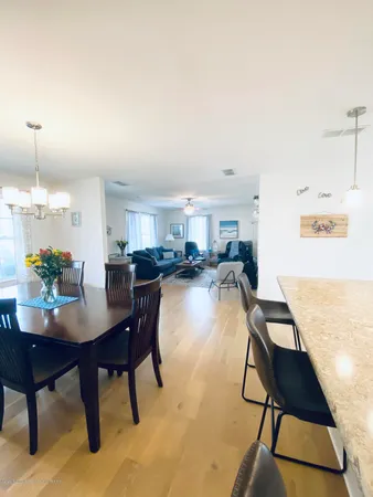 a dining room with furniture and a chandelier
