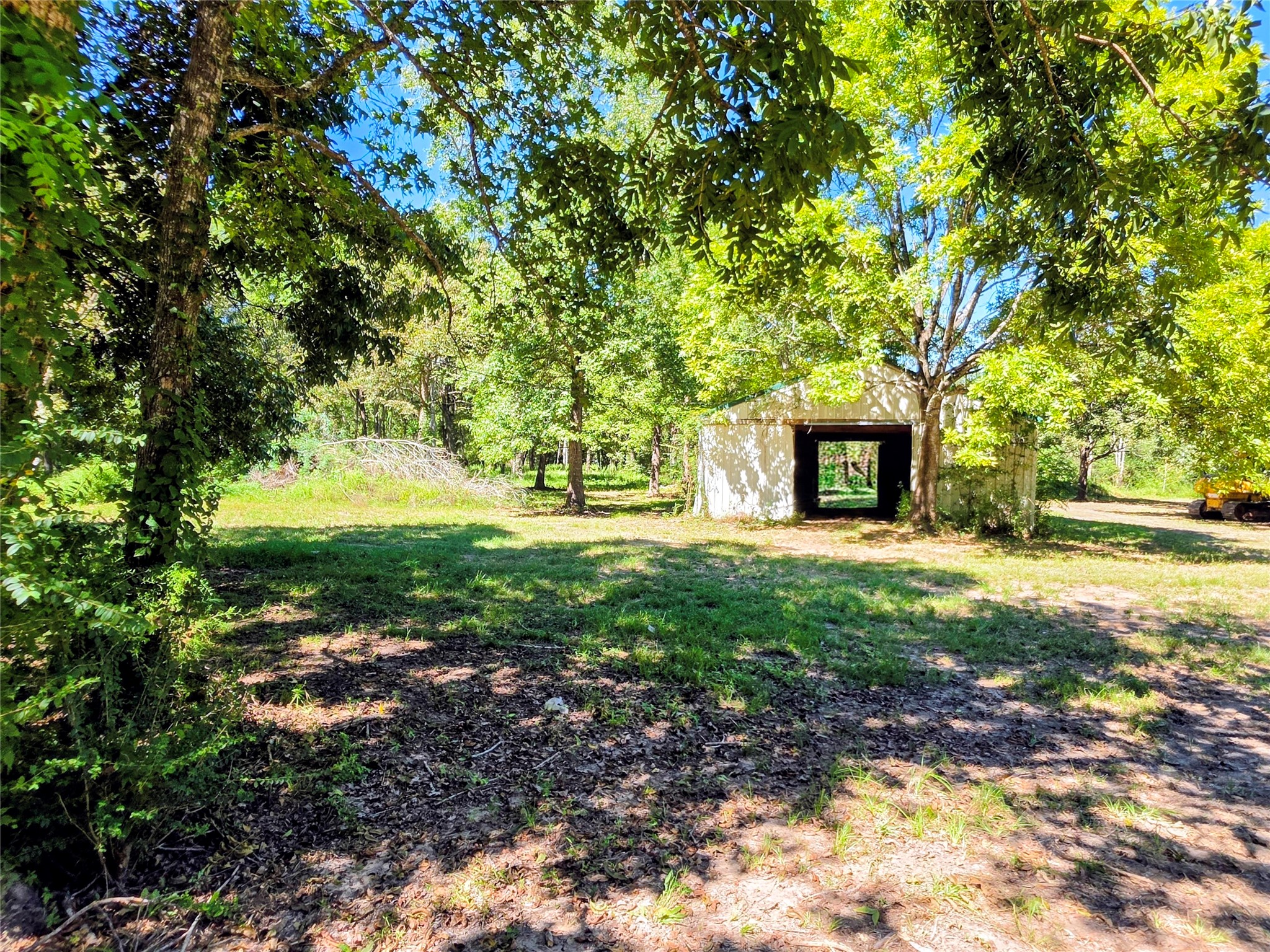 Tbd 3rd Street Batson, TX 77519 - Photo 1 of 20 Expansive wooded lot with a charming, rustic barn, perfect for peaceful country living and outdoor activities.