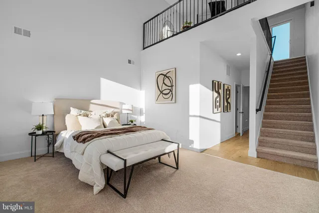 a bedroom with a bed and a night stand