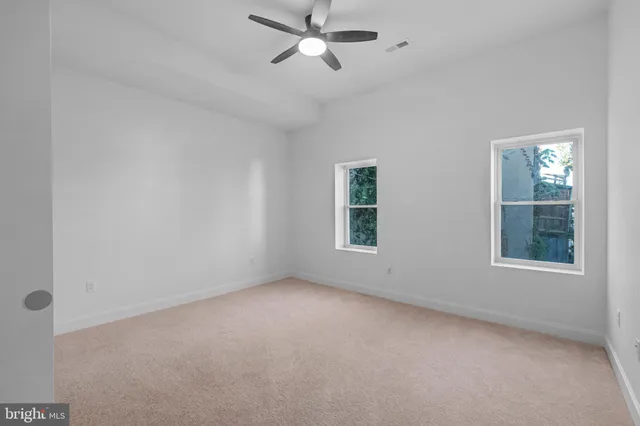 a view of a building with wooden fence