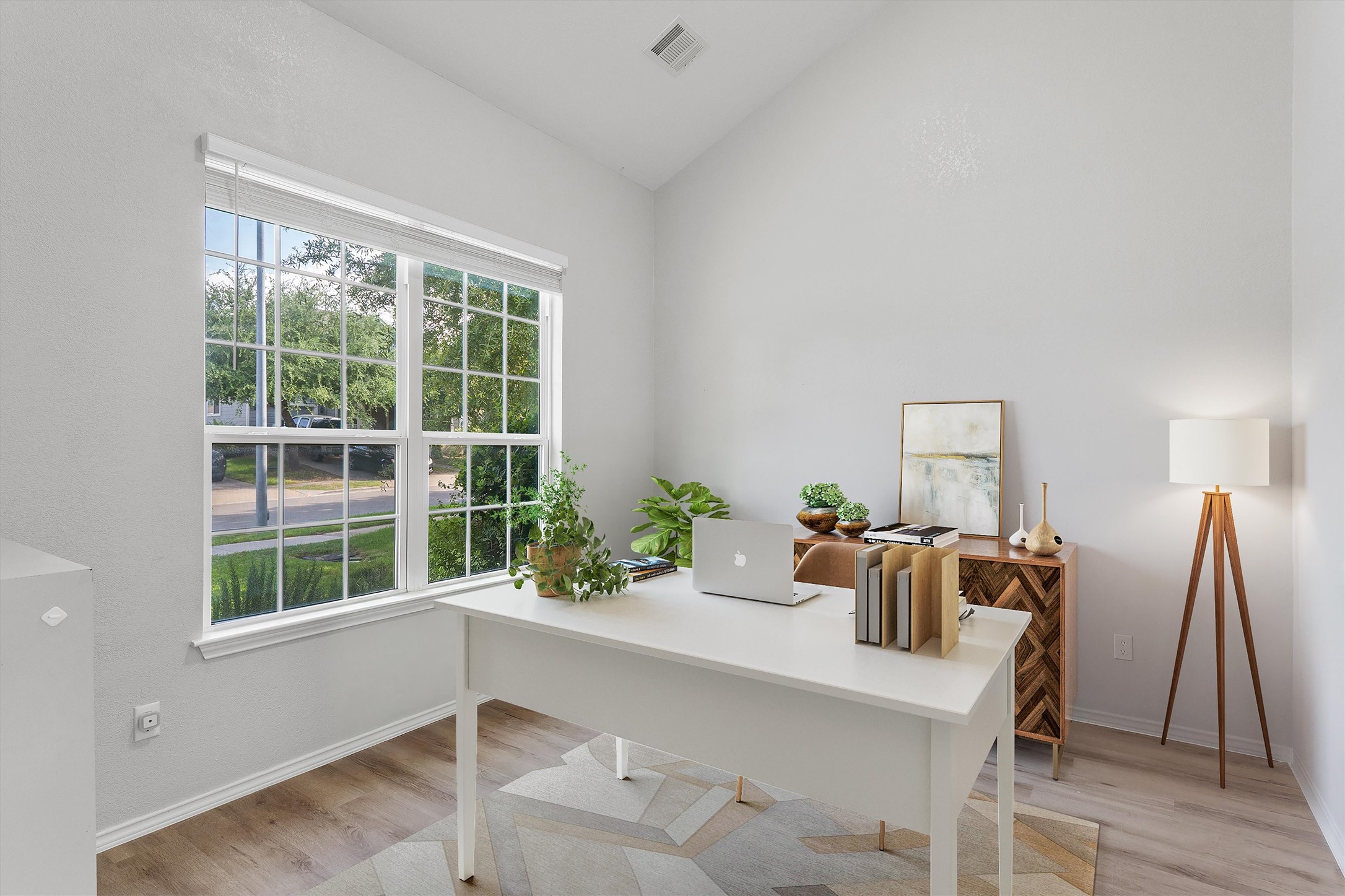 1833 Thompson Trail Round Rock, TX 78664 - Photo 7 of 40 A well-lit study with vaulted ceilings, a wide window overlooking greenery, and elegant wood flooring.