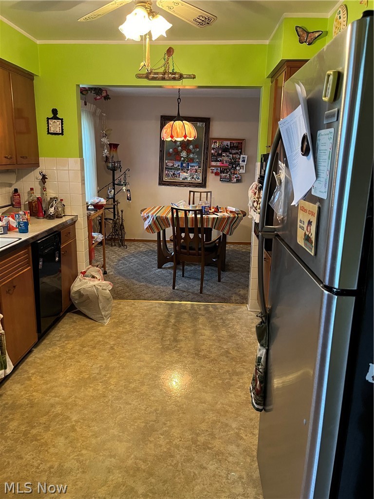 Kitchen featuring stainless steel refrigerator, backsplash, ceiling fan, crown molding, and dishwasher.