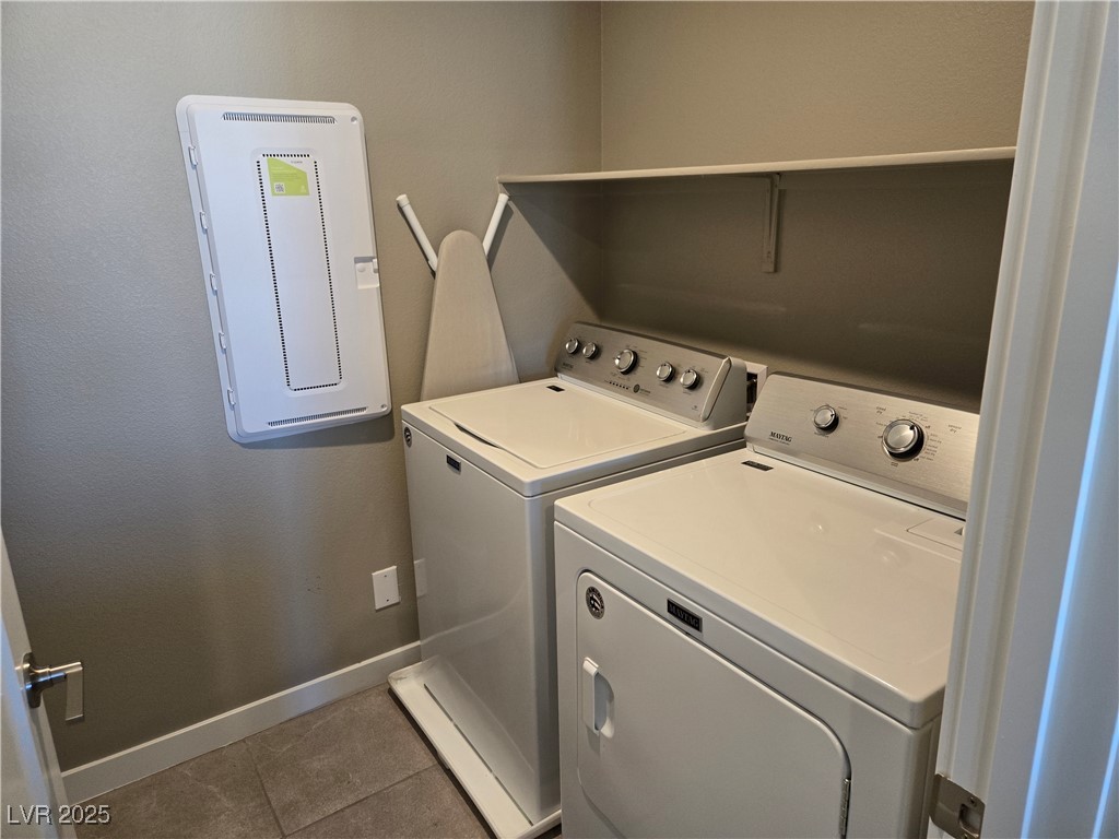 3192 Timorasso Avenue Henderson, NV 89044 - Photo 11 of 16 Laundry room with tile patterned flooring, washing machine and dryer, and electric panel