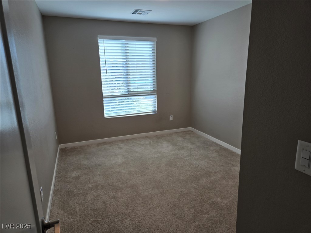 3192 Timorasso Avenue Henderson, NV 89044 - Photo 13 of 16 Spare room with light colored carpet and baseboards
