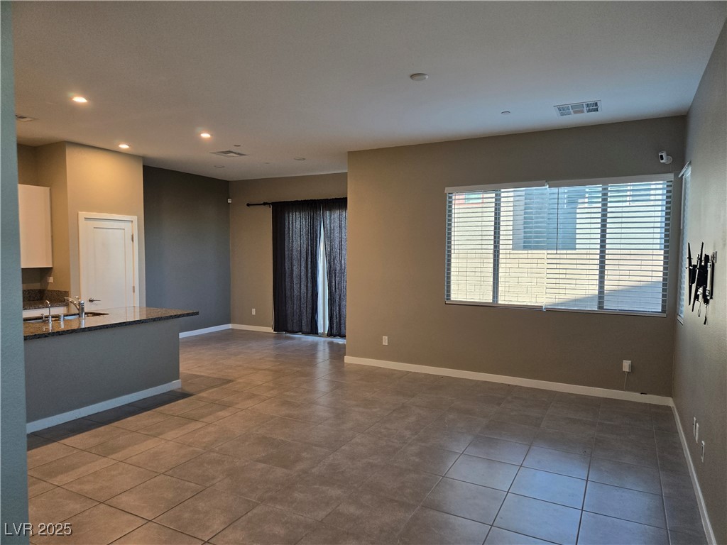 3192 Timorasso Avenue Henderson, NV 89044 - Photo 2 of 16 Unfurnished living room with recessed lighting and dark tile patterned flooring
