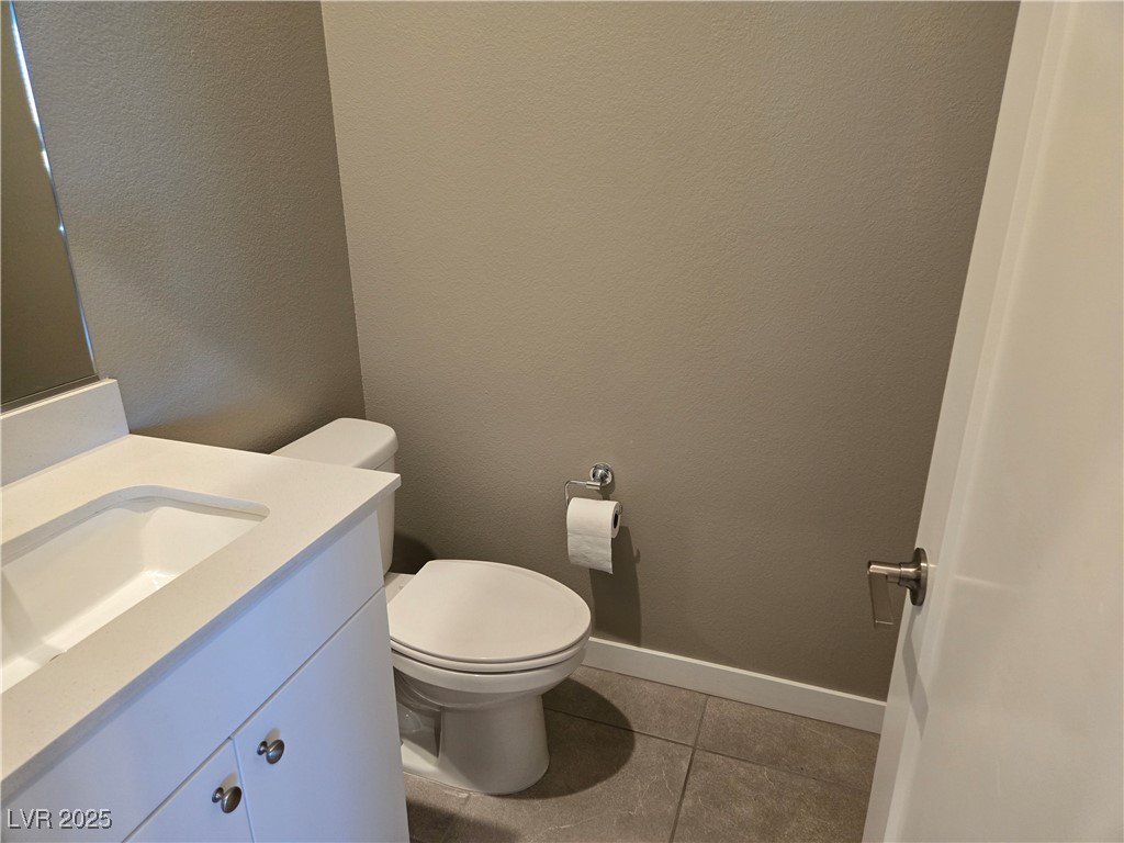 3192 Timorasso Avenue Henderson, NV 89044 - Photo 5 of 16 Bathroom featuring a textured wall, vanity, and light tile patterned floors
