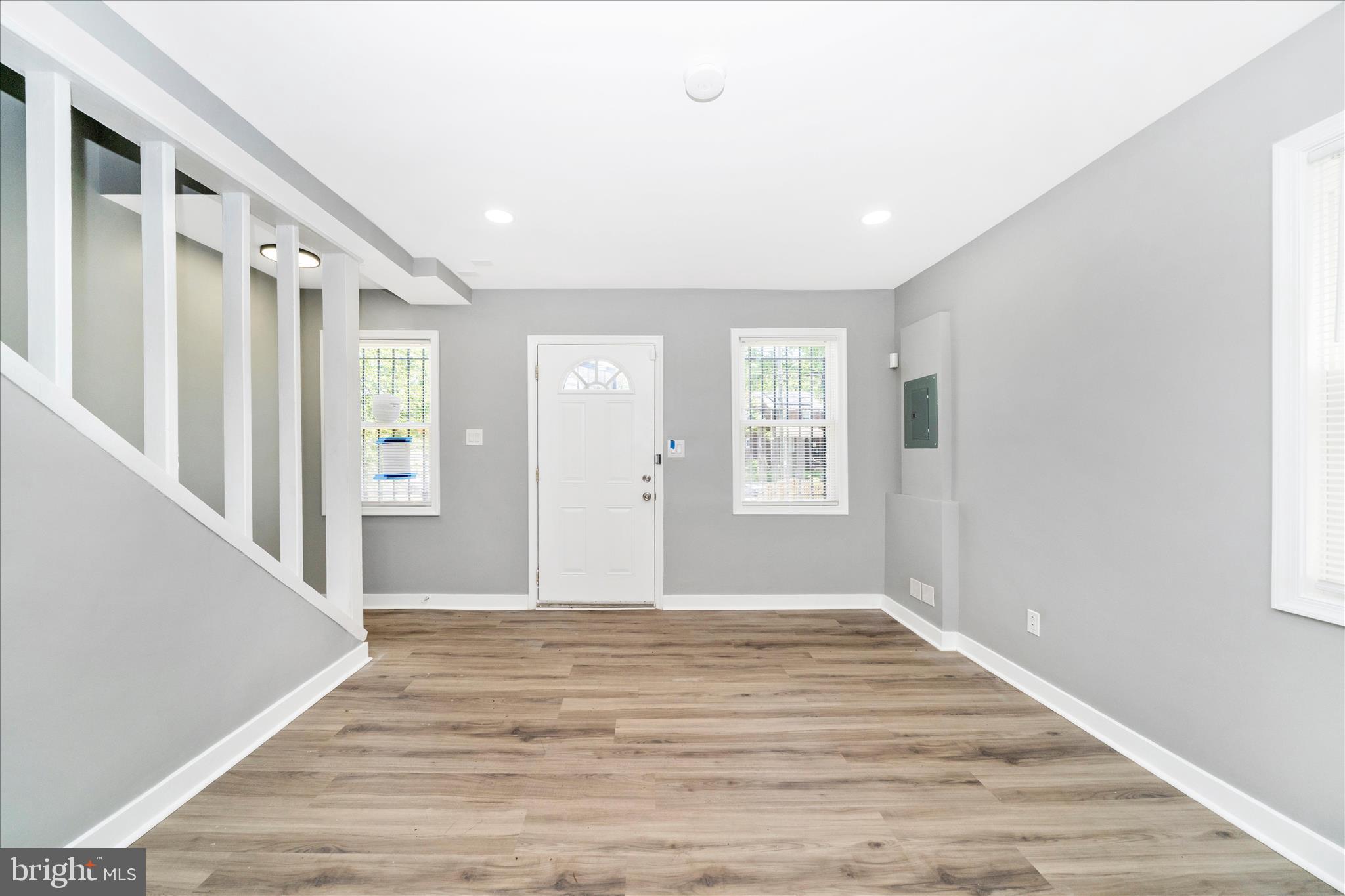 5027 Benning Road Southeast Washington, DC 20019 - Photo 6 of 57 a view of an empty room with wooden floor and a window