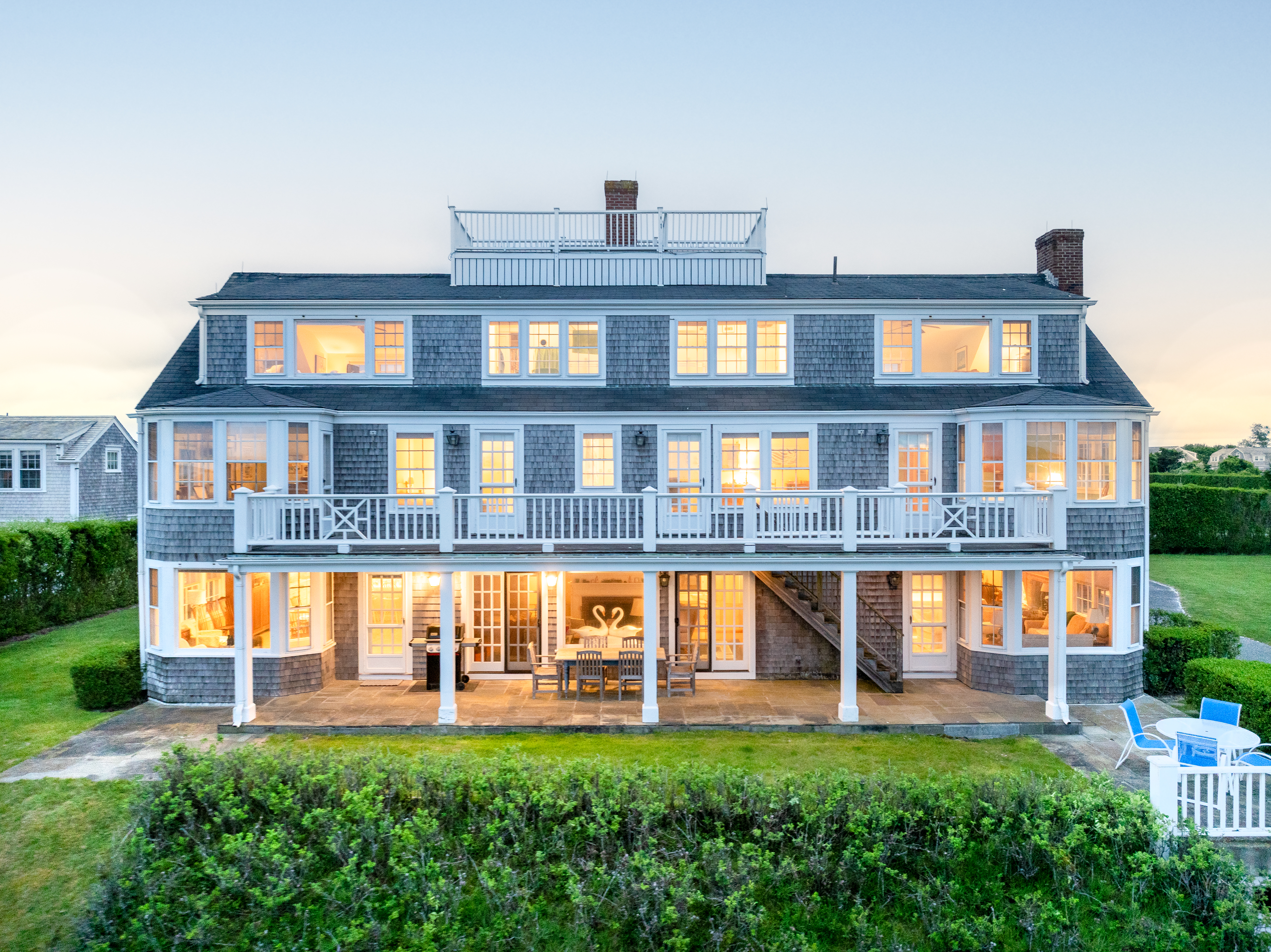 52 Monomoy Road Nantucket, MA 02554 - Photo 2 of 5 a front view of a house with a yard table and chairs