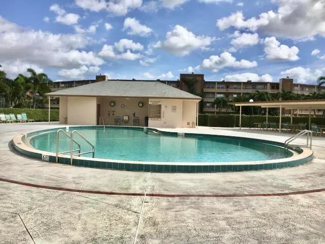 a view of a swimming pool with a yard