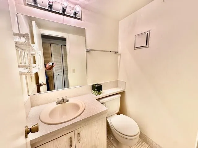 a bathroom with a sink a toilet and mirror