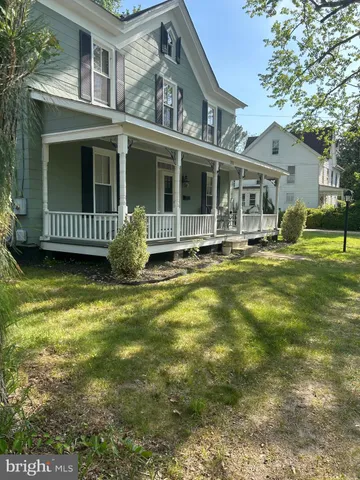 a view of a house with a yard balcony and sitting area