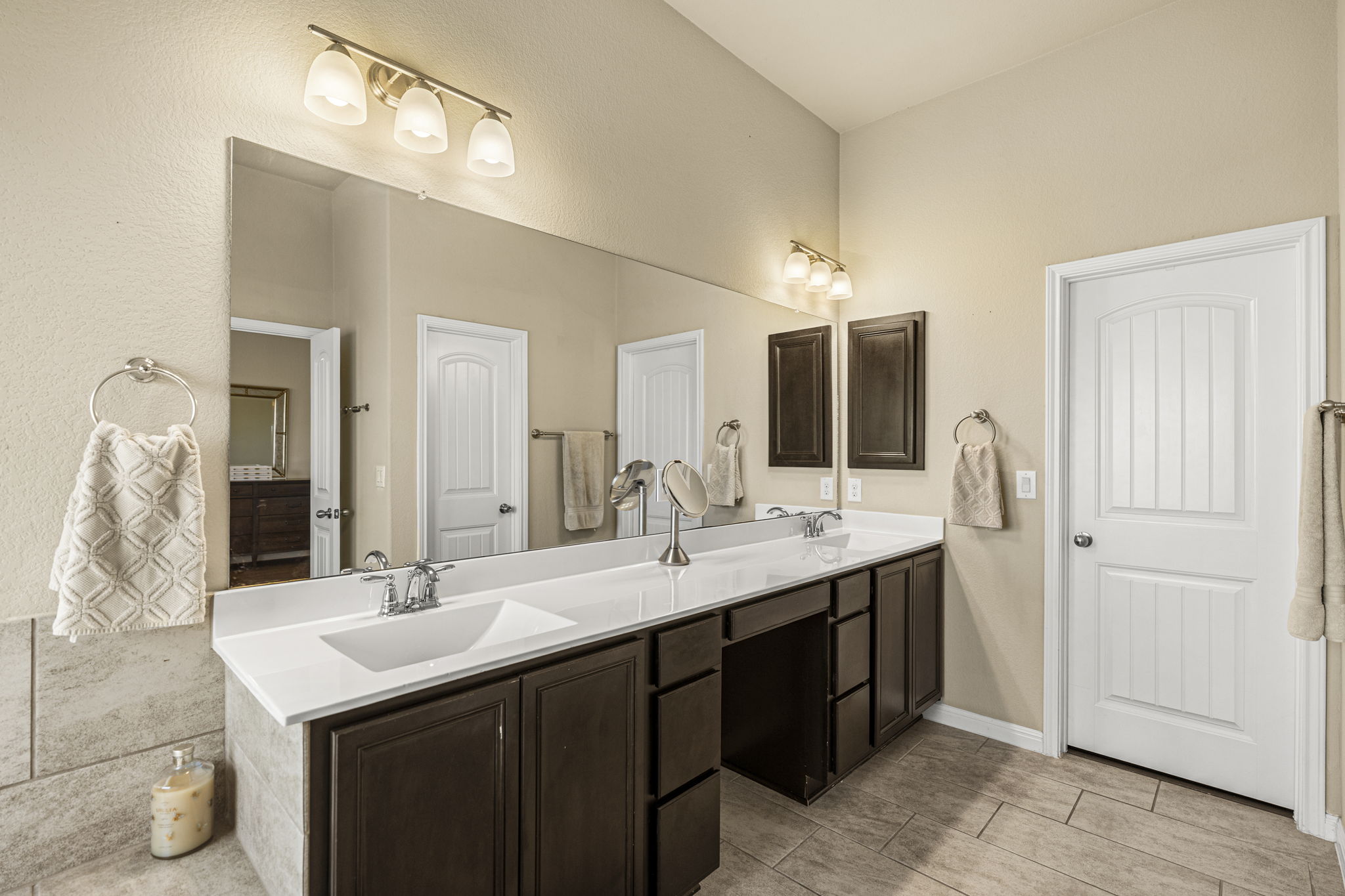 11412 Reading Way Austin, TX 78717 - Photo 14 of 35 a bathroom with a double vanity sink and a mirror