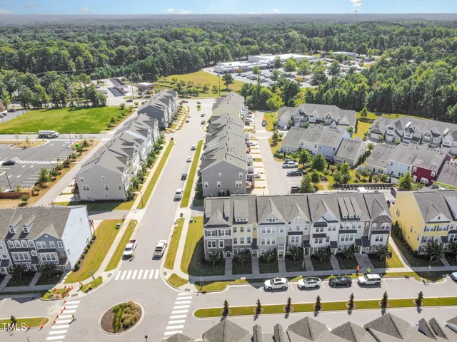 an aerial view of residential houses with outdoor space