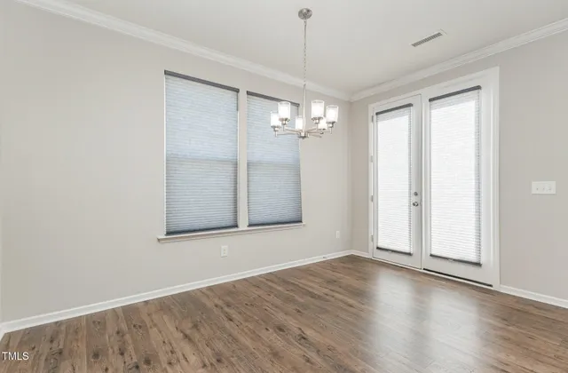 a large kitchen with stainless steel appliances granite countertop a lot of counter space and wooden floors