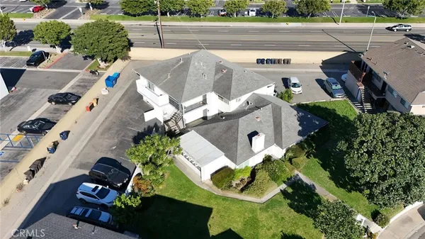 an aerial view of a house with a yard and potted plants