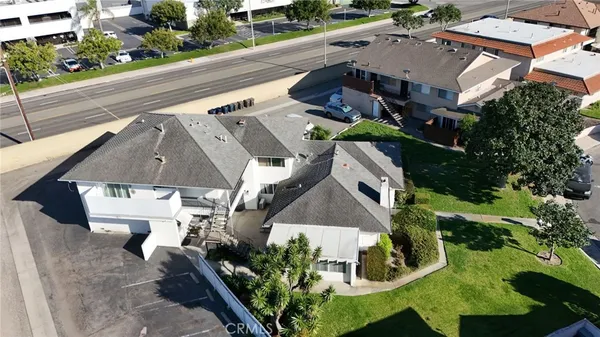 an aerial view of a house with a yard