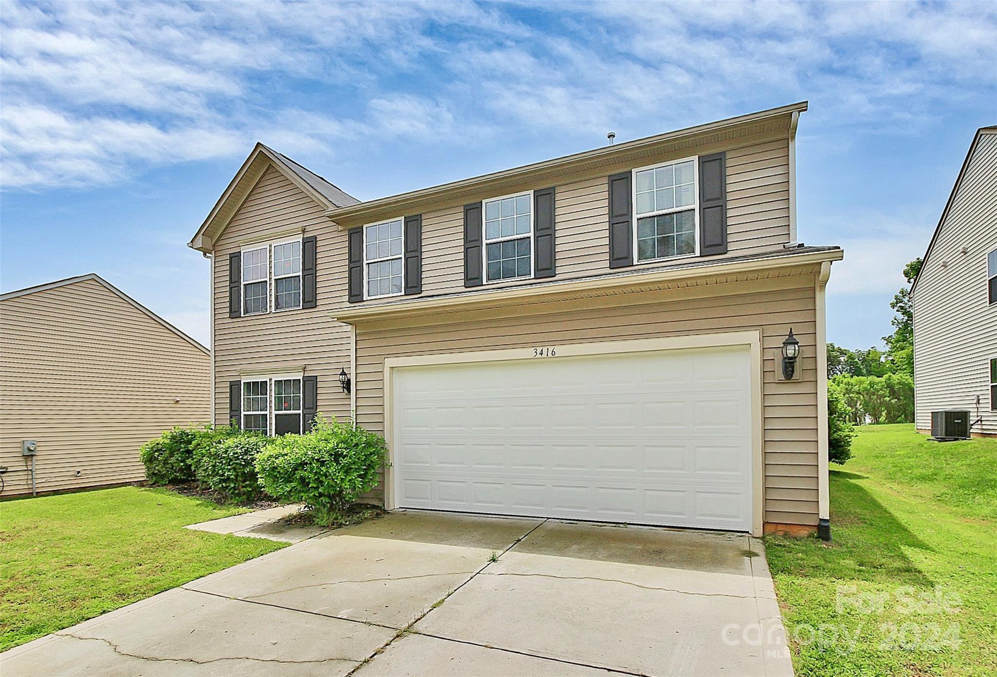 a view of backyard of house with a yard