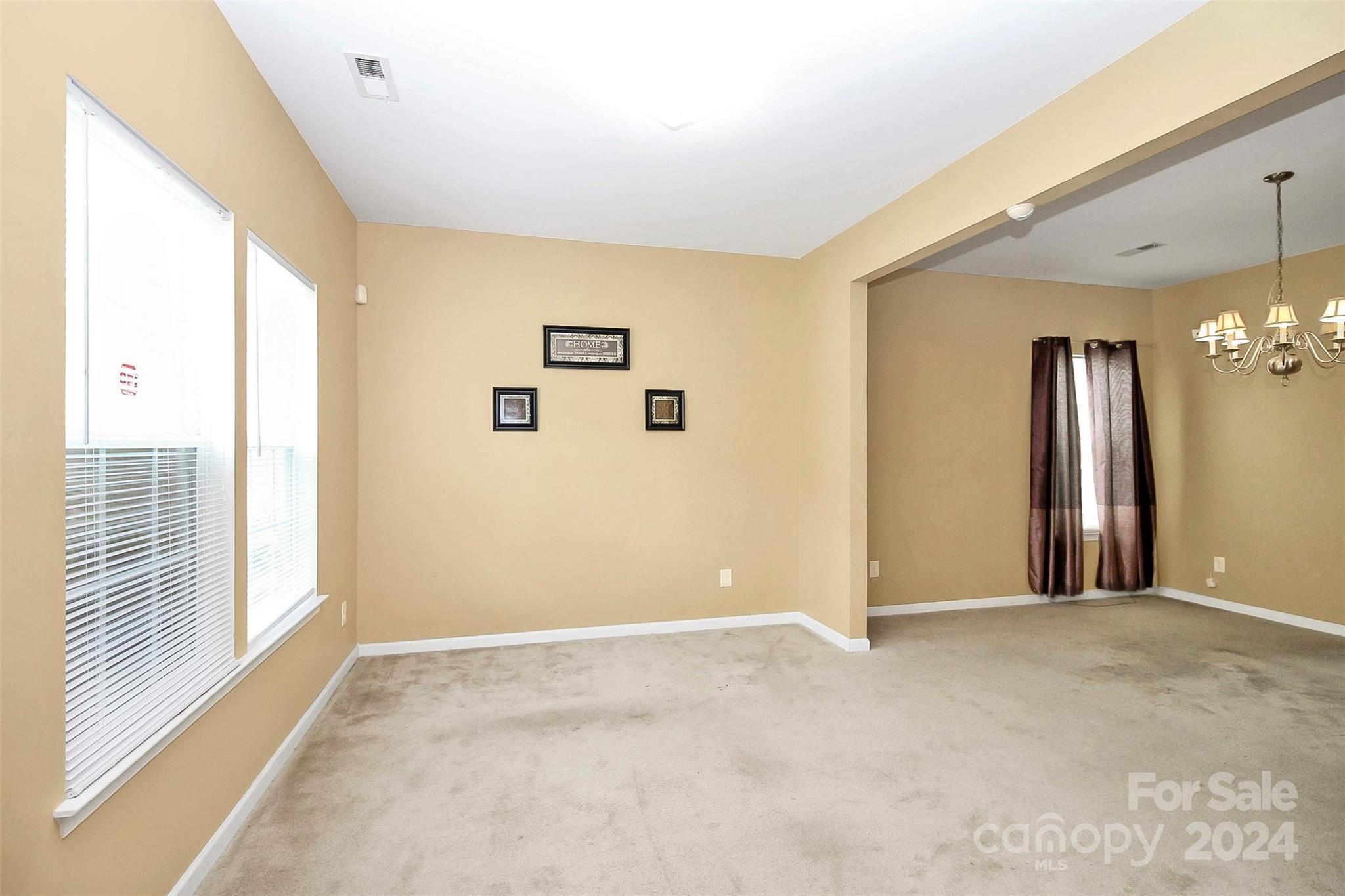 3416 Ashley View Drive Charlotte, NC 28213 - Photo 6 of 28 a view of a big room with windows and chandelier fan