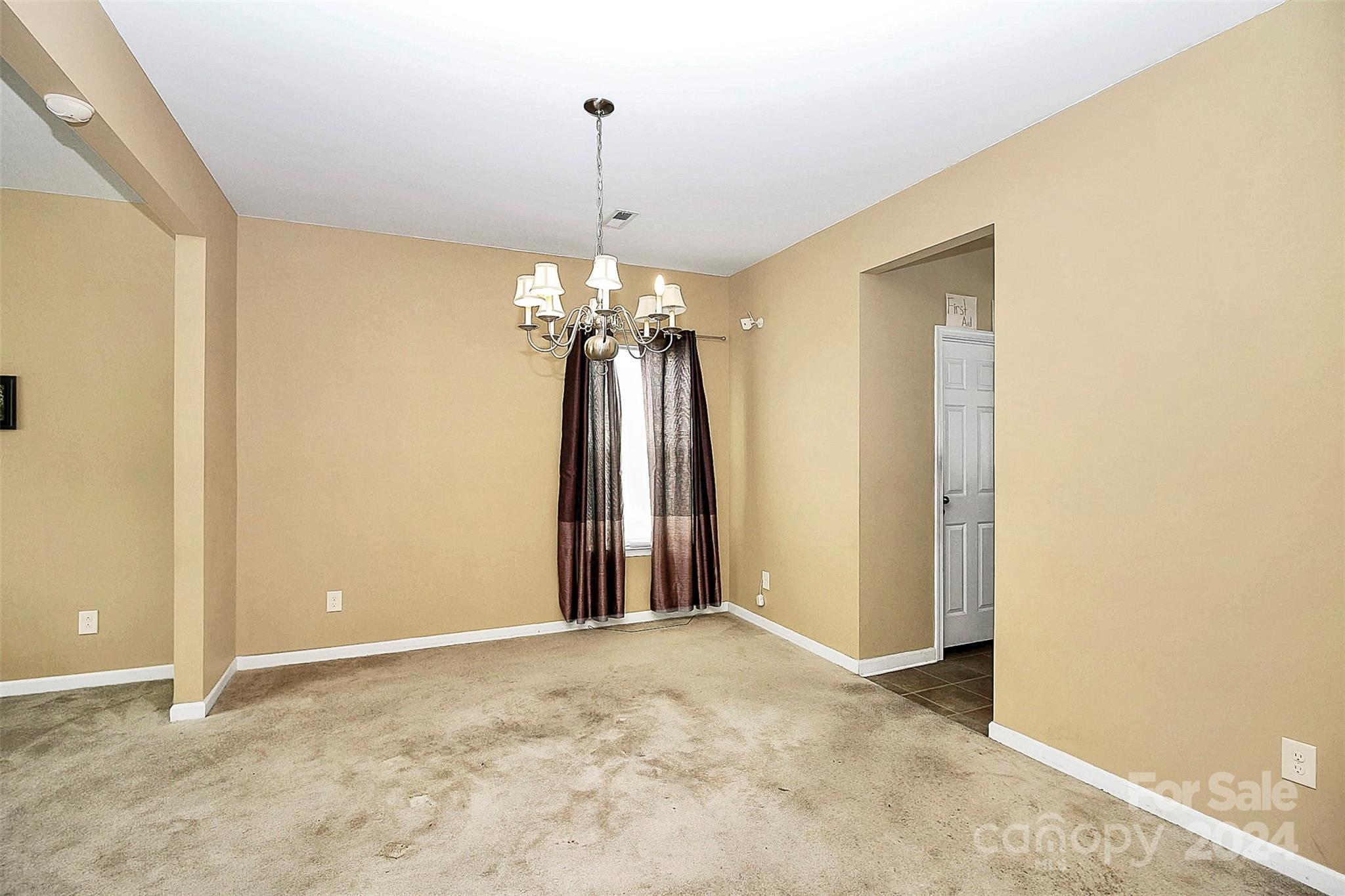 3416 Ashley View Drive Charlotte, NC 28213 - Photo 9 of 28 a view of a hallway with a chandelier fan and table in it