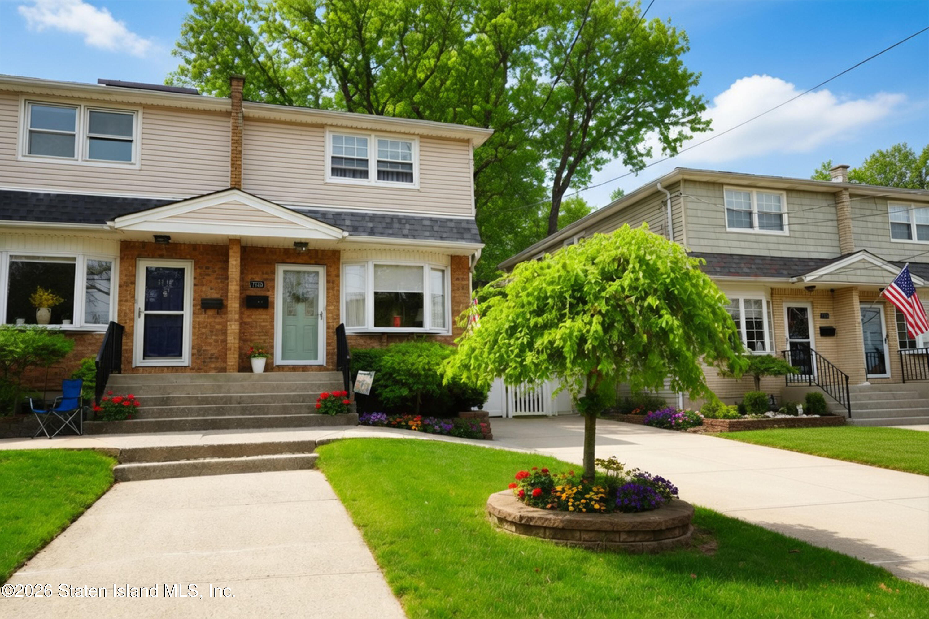 a front view of a house with a yard and trees