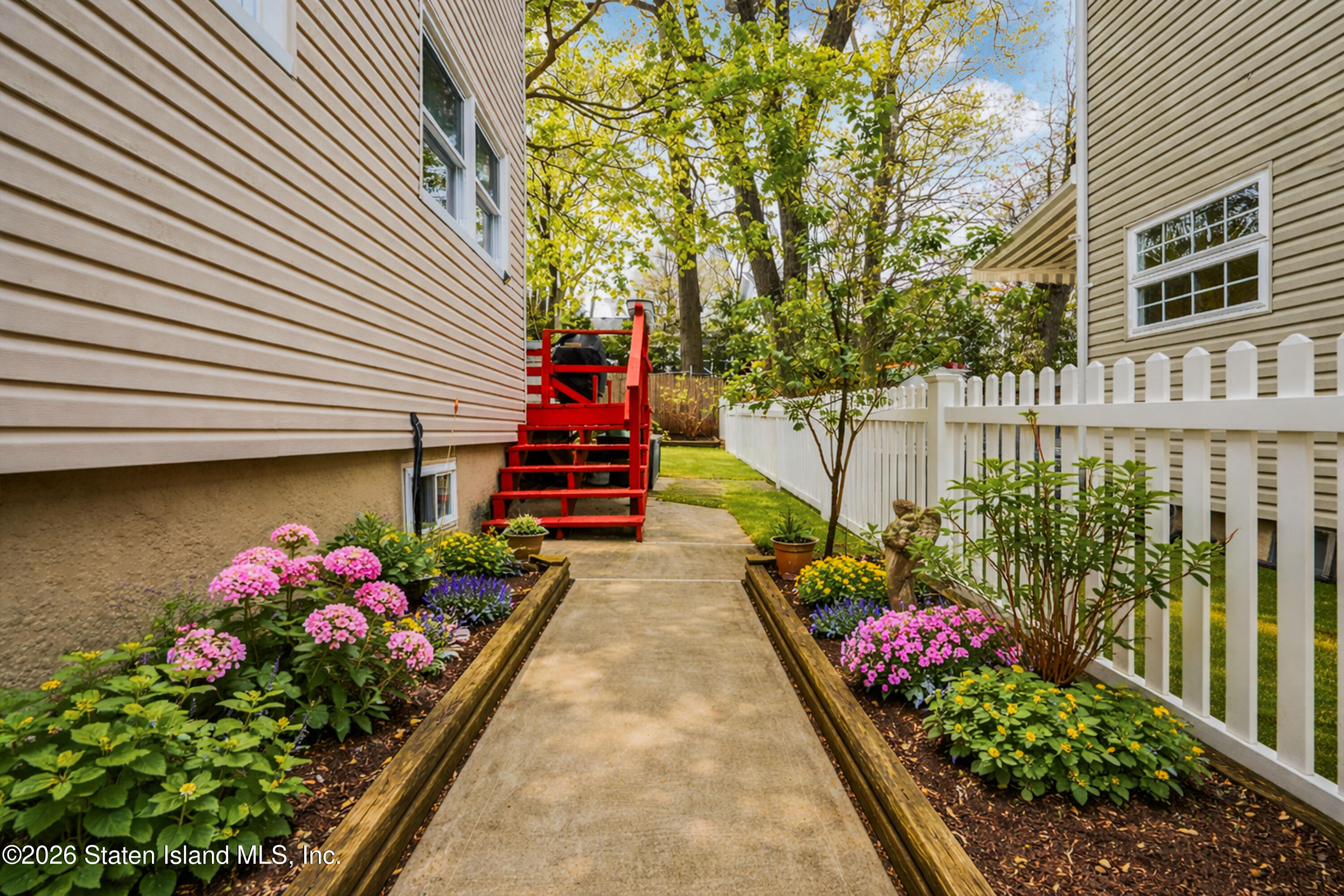 7750 Amboy Road Staten Island, NY 10307 - Photo 16 of 29 a bunch of flowers are in front of a house