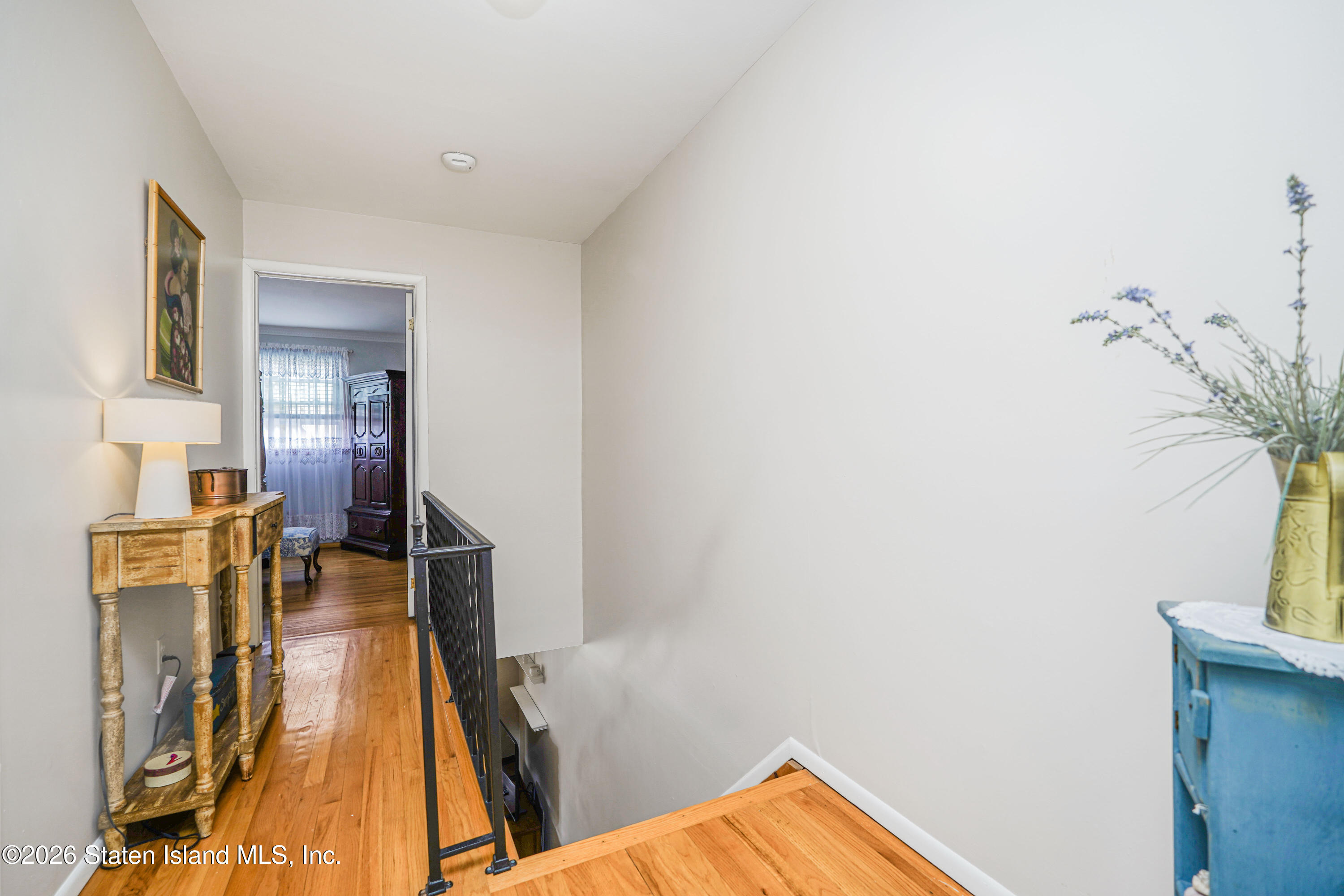 7750 Amboy Road Staten Island, NY 10307 - Photo 18 of 29 a view of a bedroom with a bed and wooden floor