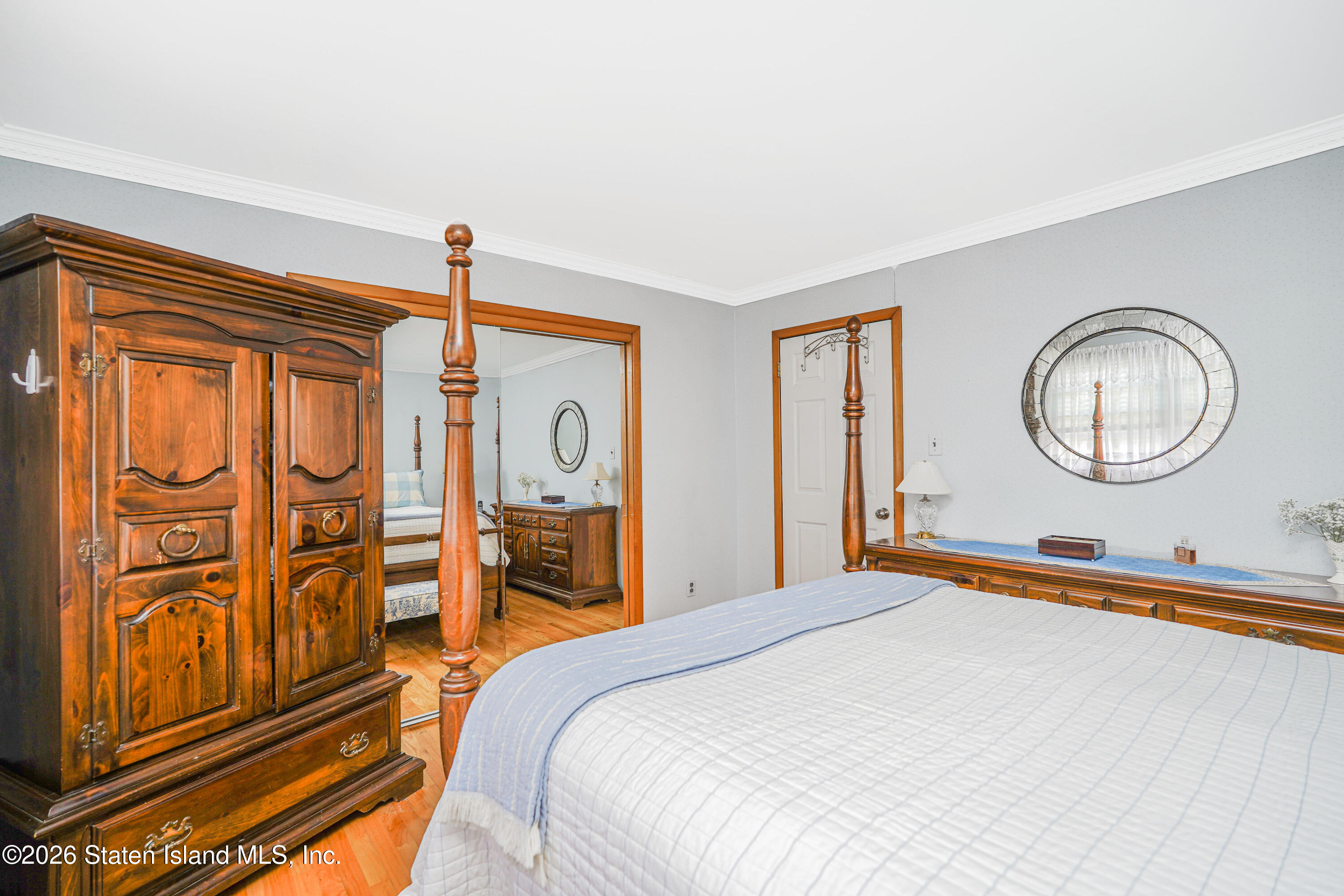 7750 Amboy Road Staten Island, NY 10307 - Photo 21 of 29 a bedroom with a large bed and a chandelier