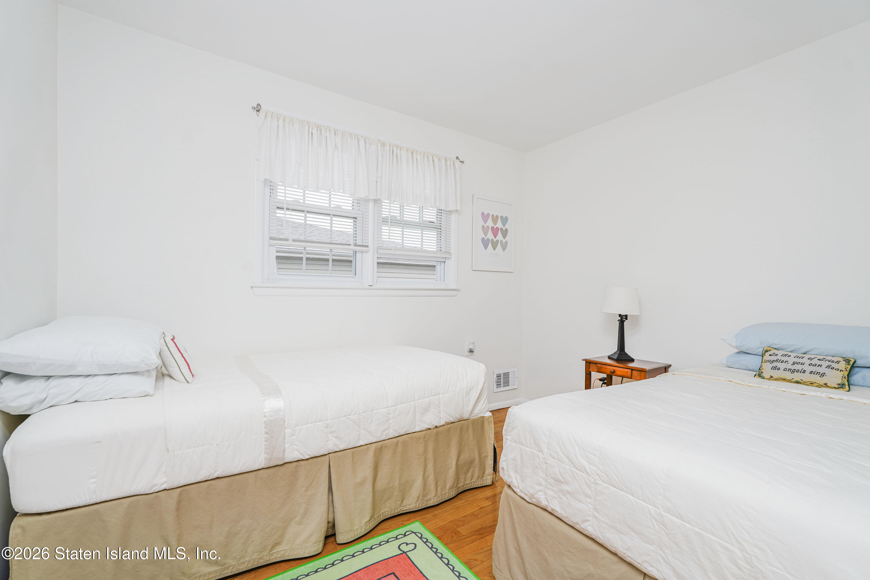 7750 Amboy Road Staten Island, NY 10307 - Photo 24 of 29 a bedroom with a bed and wooden floor