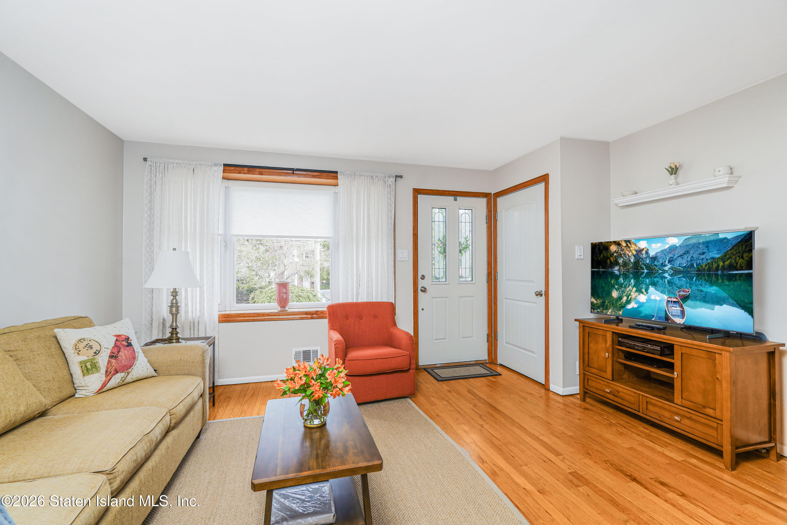 7750 Amboy Road Staten Island, NY 10307 - Photo 5 of 29 a living room with furniture a flat screen tv and floor to ceiling window