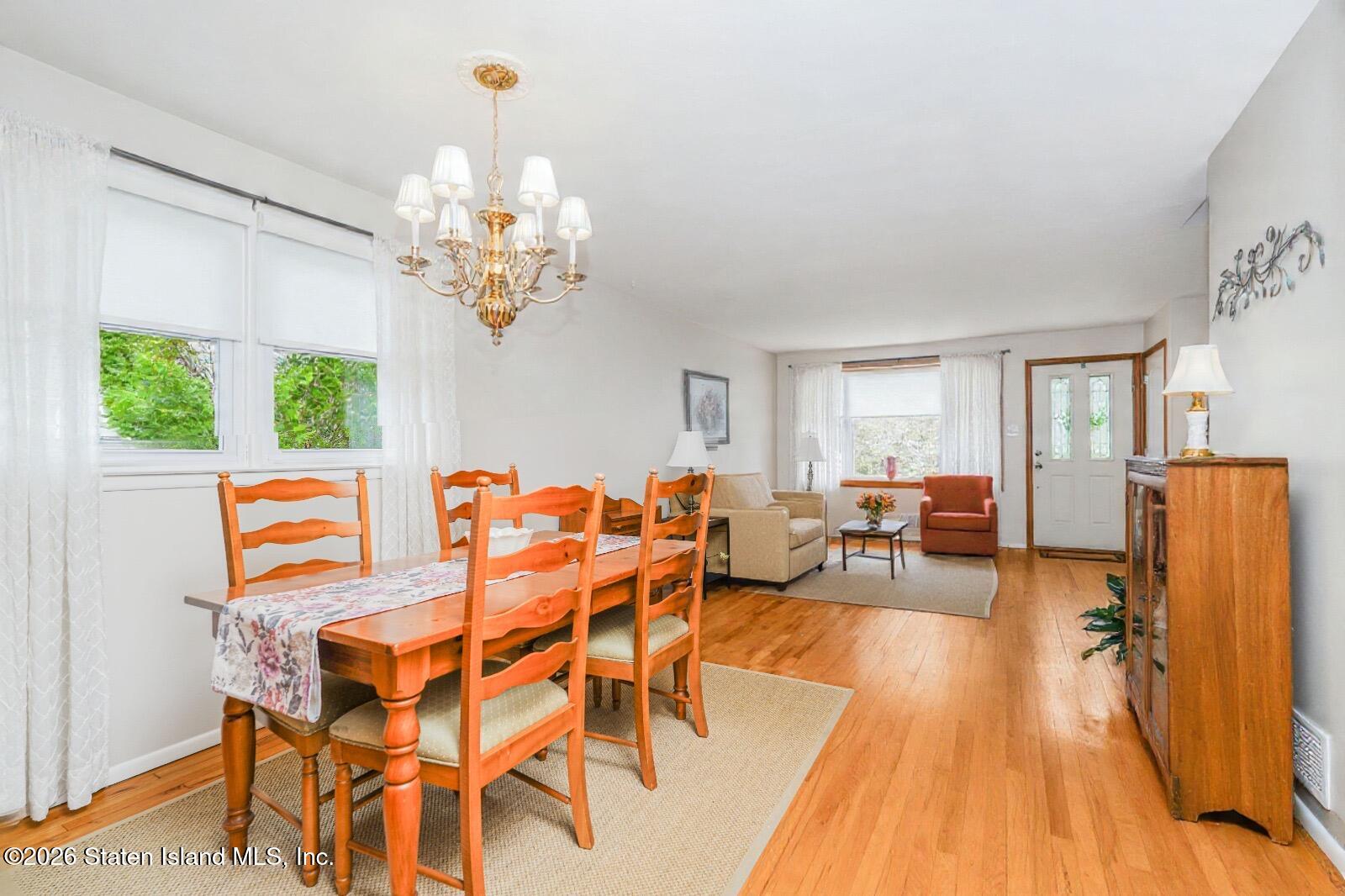 7750 Amboy Road Staten Island, NY 10307 - Photo 6 of 29 a view of a dining room with furniture a chandelier and wooden floor