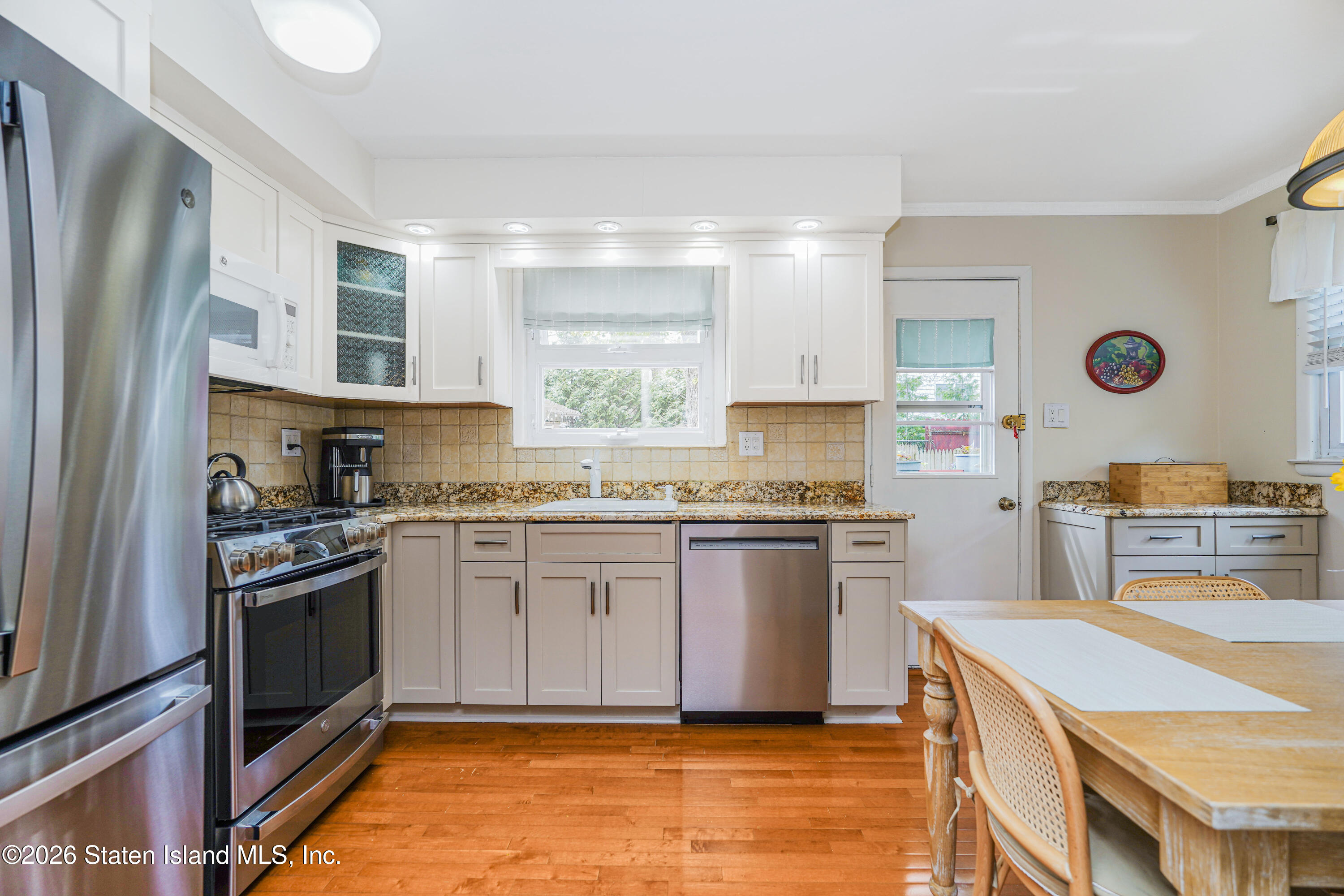 7750 Amboy Road Staten Island, NY 10307 - Photo 8 of 29 a kitchen with stainless steel appliances granite countertop a stove a sink and a refrigerator