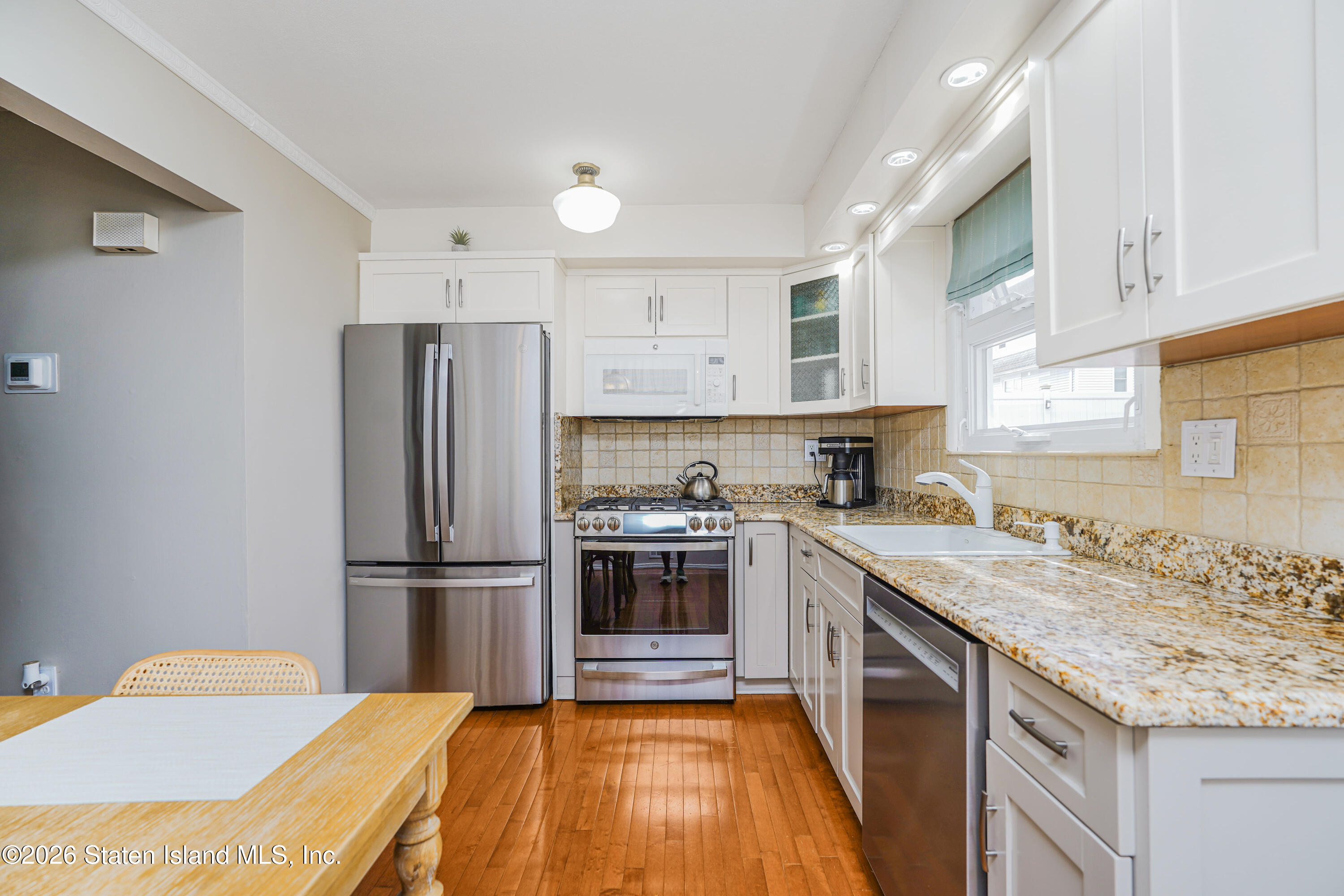 7750 Amboy Road Staten Island, NY 10307 - Photo 10 of 29 a kitchen with kitchen island a sink appliances and cabinets