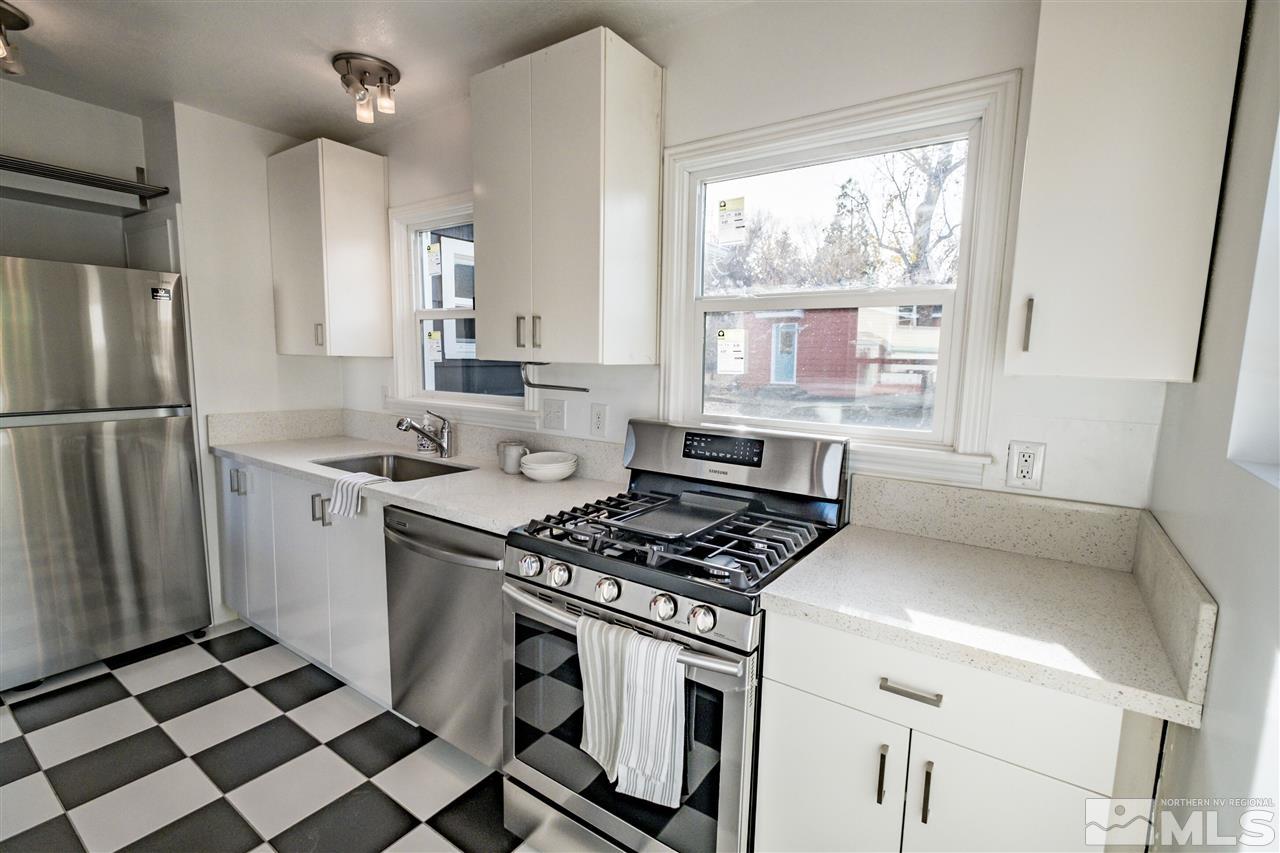 951 Watt Street Reno, NV 89509 - Photo 3 of 11 a kitchen with a stove a refrigerator and a sink