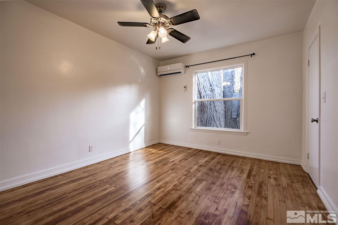 951 Watt Street Reno, NV 89509 - Photo 7 of 11 wooden floor in an empty room with a window