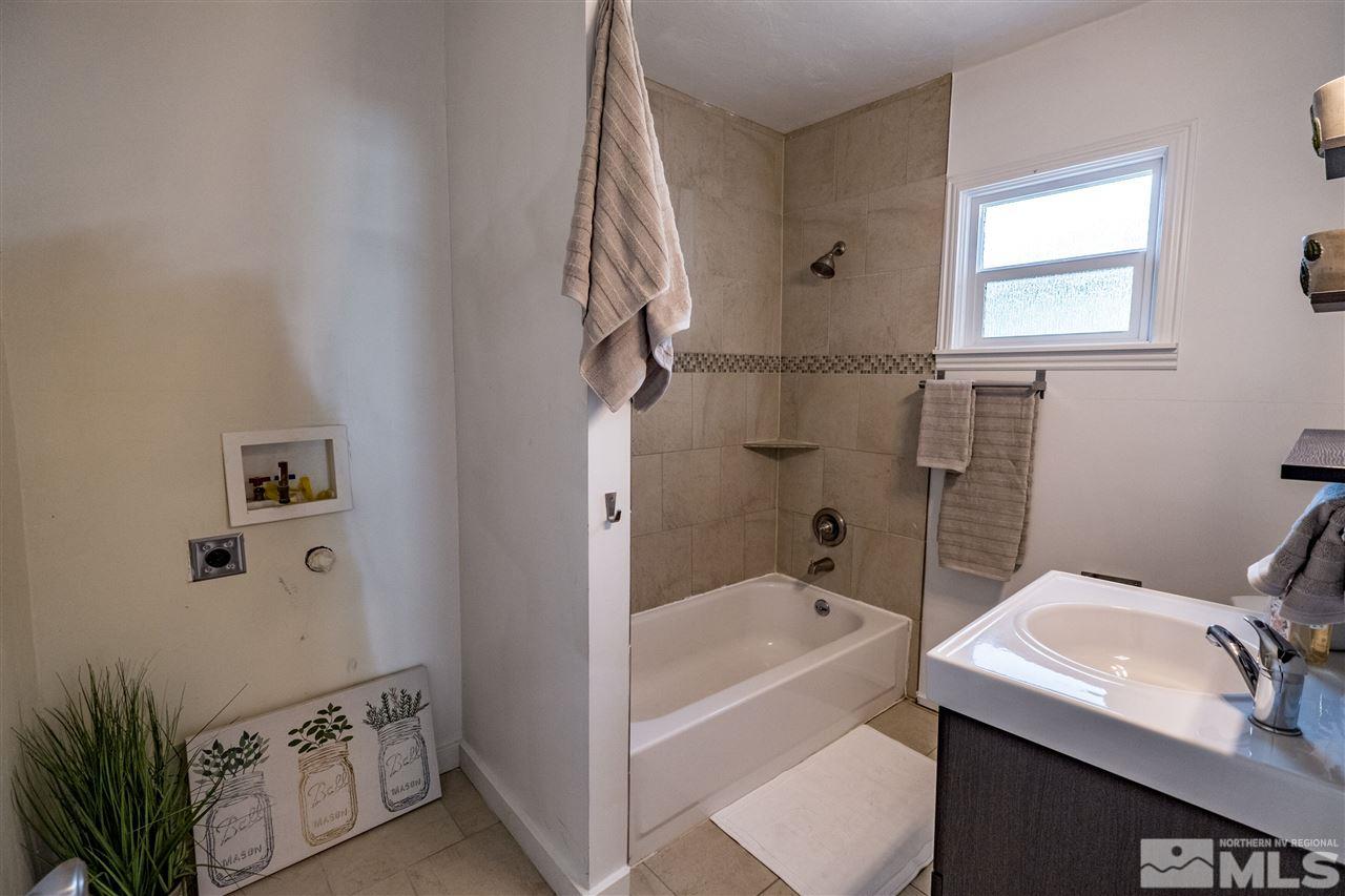 951 Watt Street Reno, NV 89509 - Photo 9 of 11 a bathroom with a sink a bathtub and shower