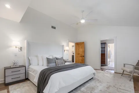 a spacious bathroom with a granite countertop sink and a mirror