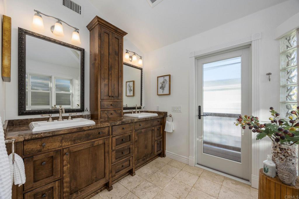 371 La Mesa Avenue Encinitas, CA 92024 - Photo 19 of 30 a spacious bathroom with a granite countertop sink and a mirror