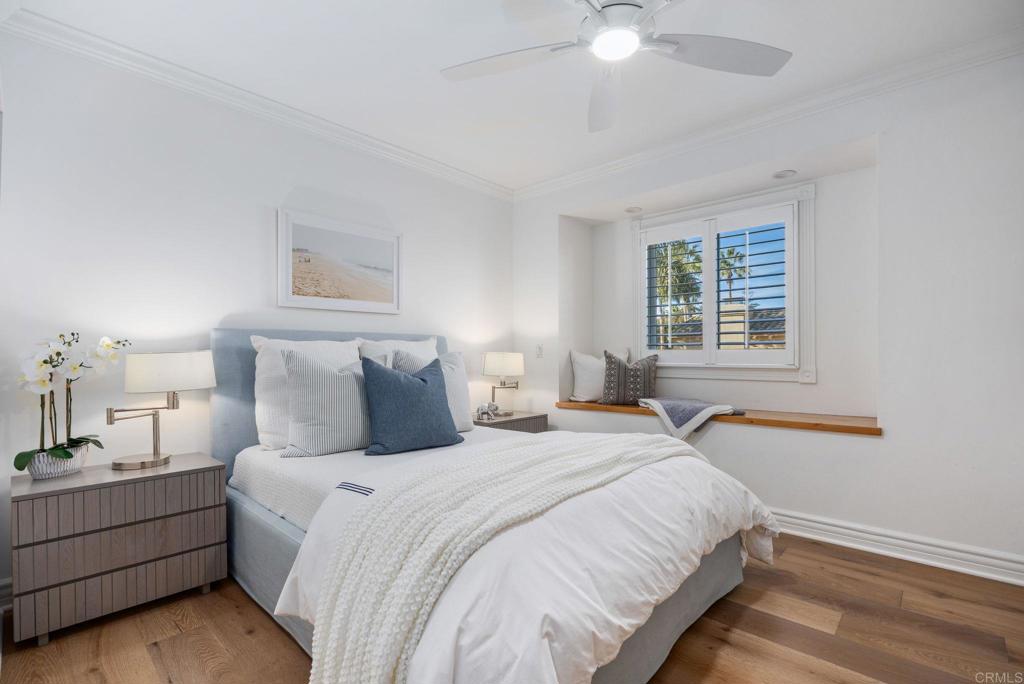 371 La Mesa Avenue Encinitas, CA 92024 - Photo 23 of 30 a bedroom with a bed and a chandelier