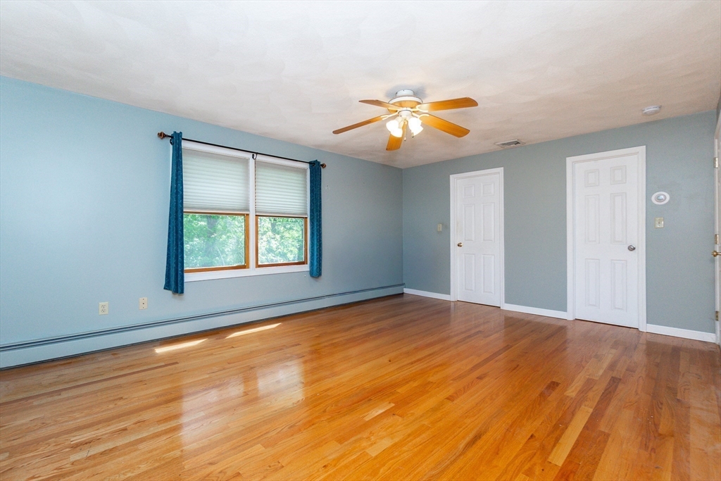 63 Bow Street Saugus, MA 01906 - Photo 23 of 42 a view of an empty room with window and wooden floor