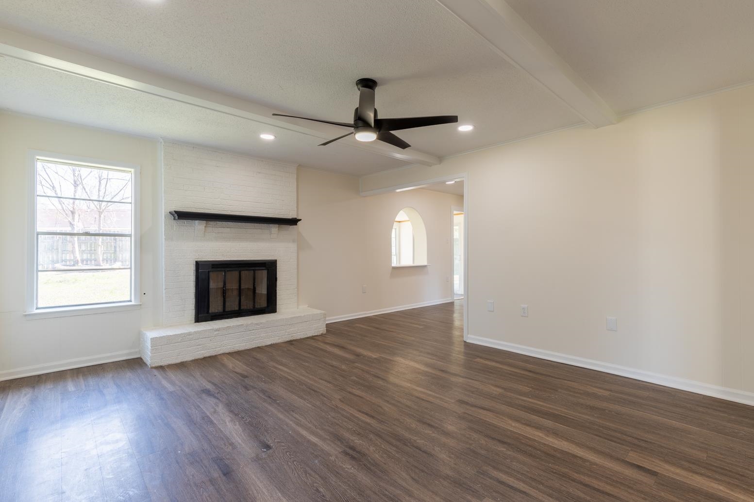 3268 Altruria Road Bartlett, TN 38134 - Photo 17 of 25 an empty room with wooden floor fireplace and windows