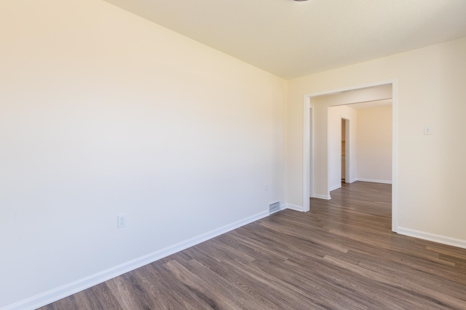 3268 Altruria Road Bartlett, TN 38134 - Photo 5 of 25 a view of an empty room with wooden floor and a window