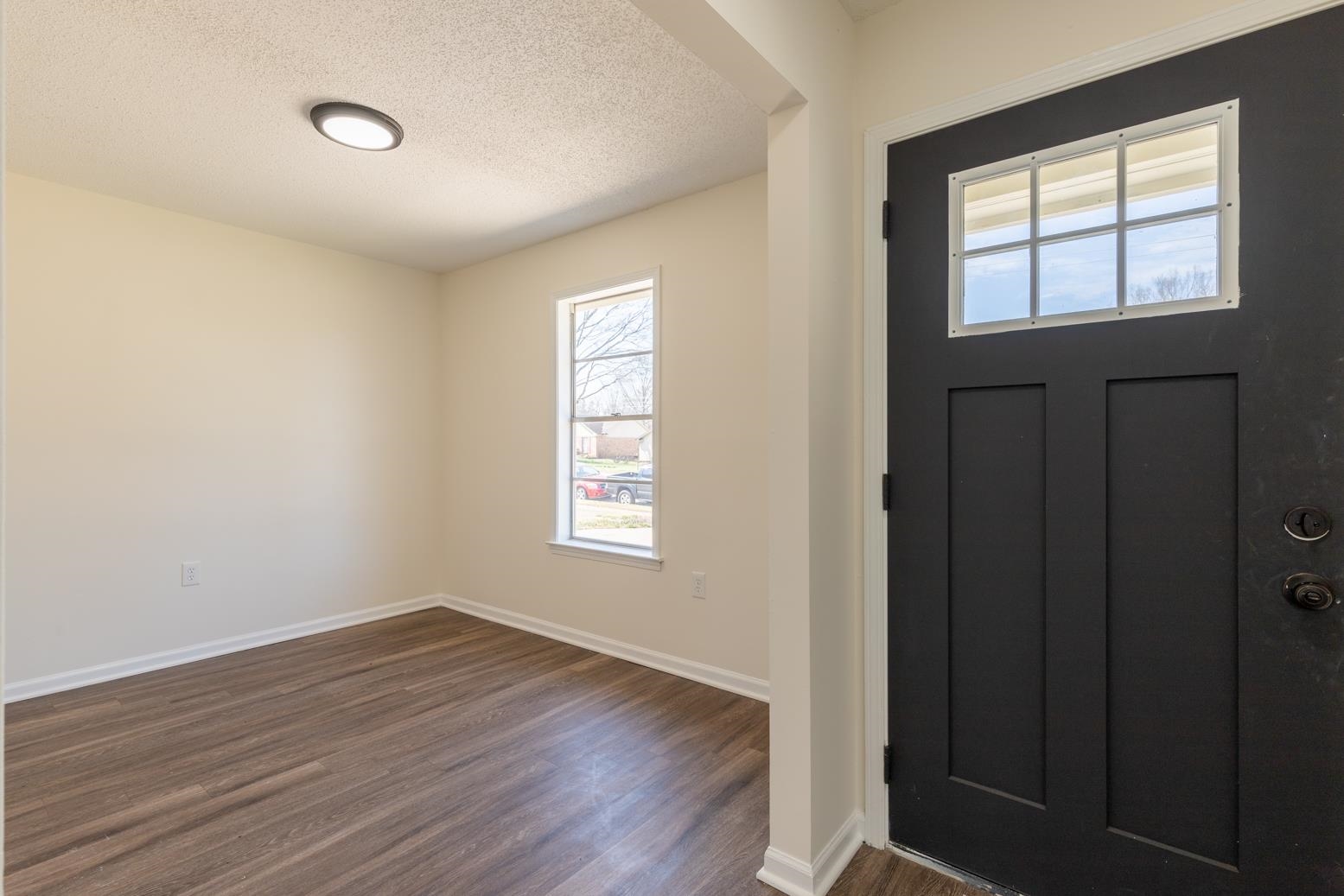 3268 Altruria Road Bartlett, TN 38134 - Photo 6 of 25 a view of an empty room with wooden floor and a window