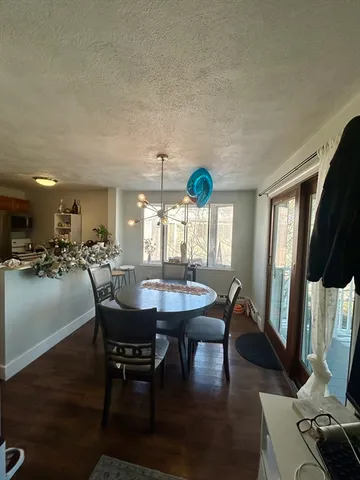 a view of a dining room with furniture and a floor to ceiling window