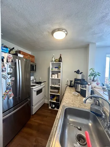 a kitchen with a refrigerator and a sink