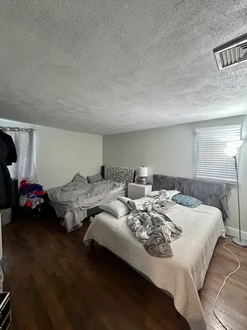 a bedroom with bed and a couch