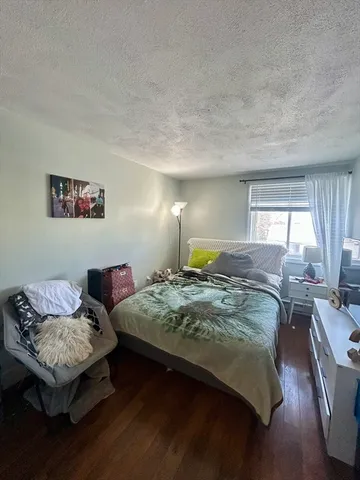 a bedroom with bed couch and window