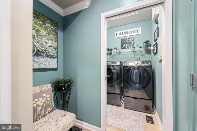 a dining room with furniture a chandelier and wooden floor